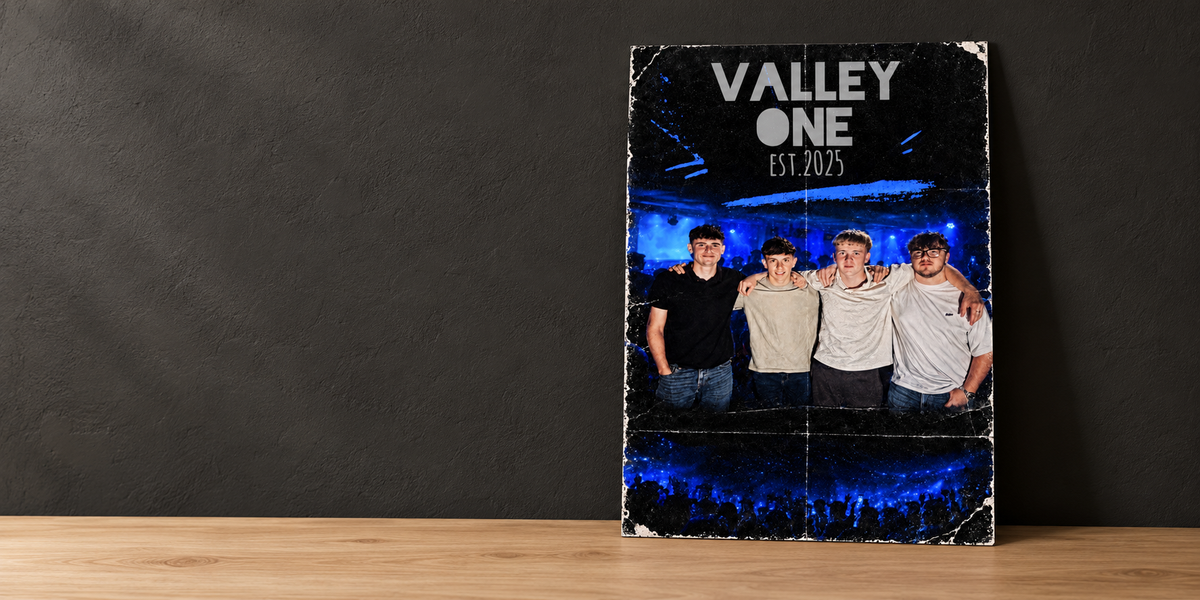 The blue and black Valley One EST. 2025 poster leaning against a charcoal wall