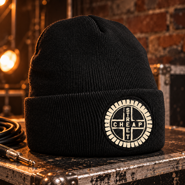 Cheap Street logo beanie in black with the warm cream Cheap Street emblem on the cuff patch, on a flight case