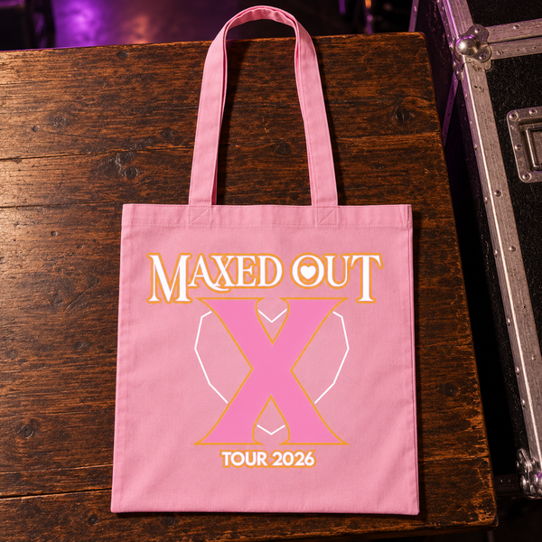 Pink X Tour 2026 tote bag laid on a wooden table