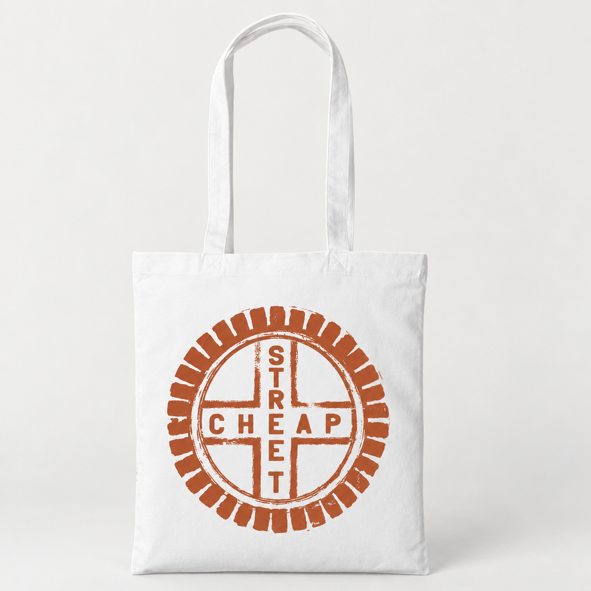 Cheap Street logo tote bag in white with a large circular Cheap Street emblem in terracotta on the front