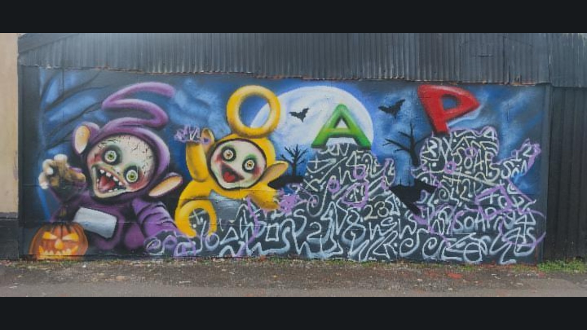 SOAP's Halloween mural in progress: the purple S and yellow O characters are painted, with the green A and red P figures still outlined